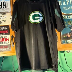 Majestic Black Tee with Packers  CB logo on front and written on back.